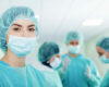 Young female surgeon with medical team in back before surgery